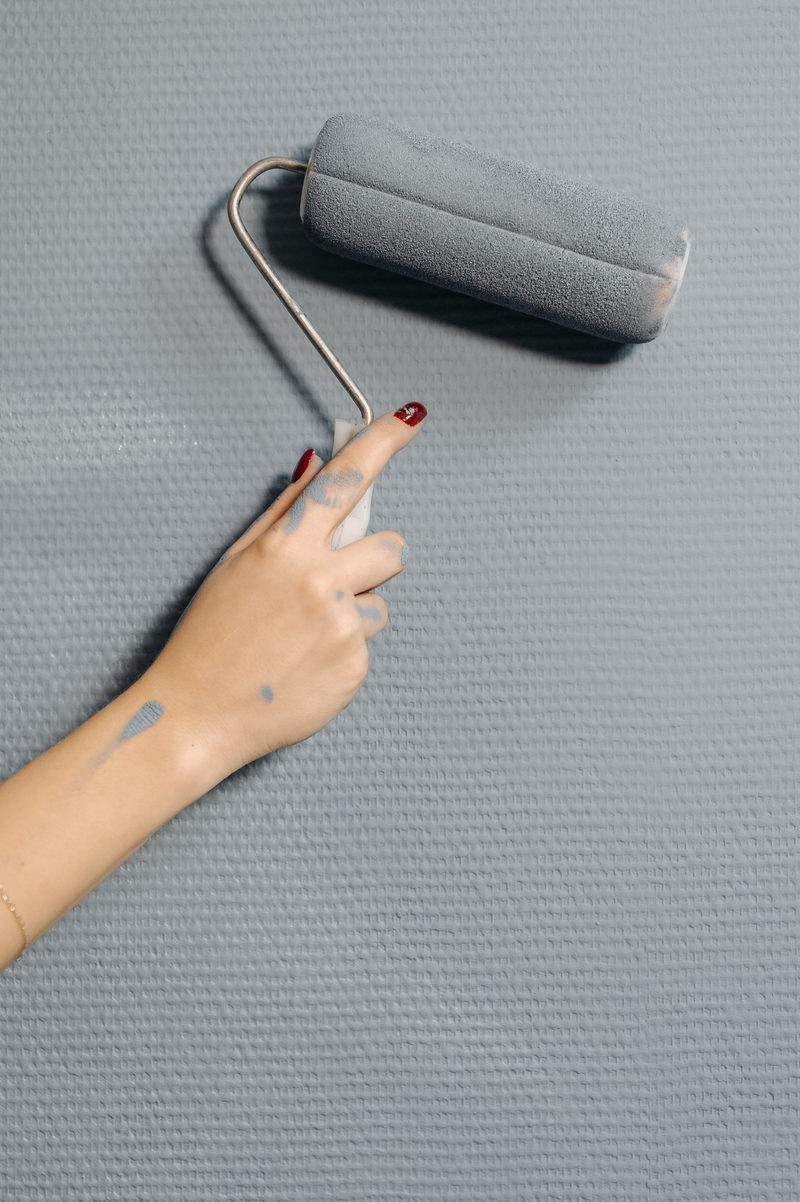 Paint roller applying a fresh wall finish